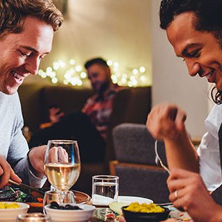Two Men and Woman Eating at a Restaurant - Lead Image for Family Dining Page