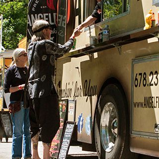 Customers Lined Up and Buying Food - Lead Image for Food Trucks Page