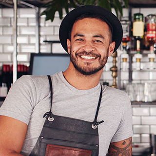 Inszone Insurance Restaurant & Bar Page Banner - Male Wearing Apron Standing