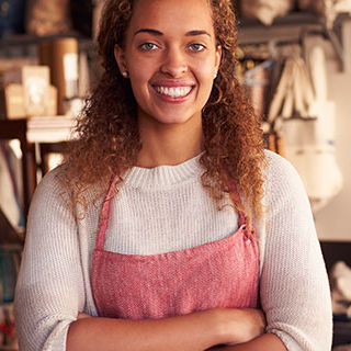 Female Shop Owner Standing - Lead Image for Retail Shops Page