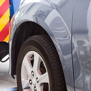 Inszone Insurance Towing and On-Hook Page Banner - Tow Truck Towing a Vehicle