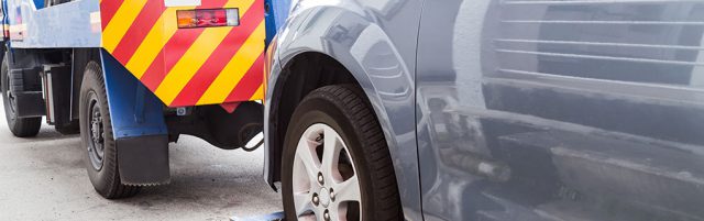 Inszone Insurance Towing and On-Hook Page Banner - Tow Truck Towing a Vehicle
