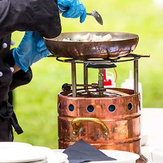 Man Cooking Using Portable Cooker - Lead Image for Vendors Page